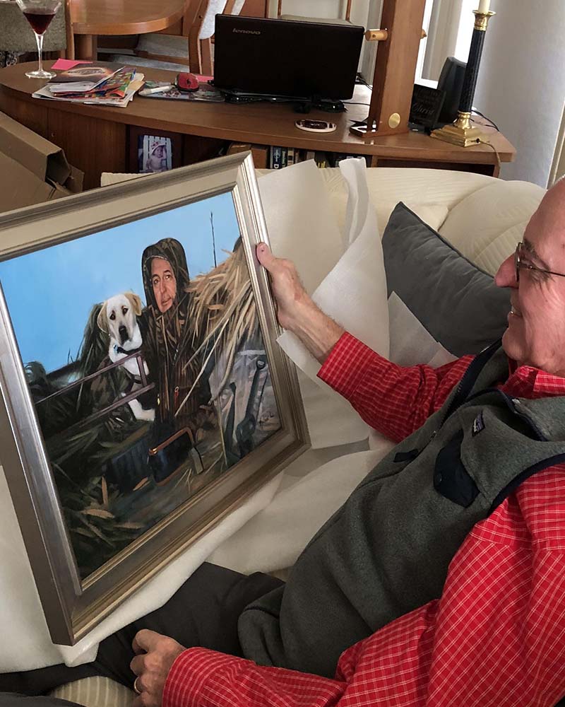 Framed portrait of a man and his dog in hunting attire.