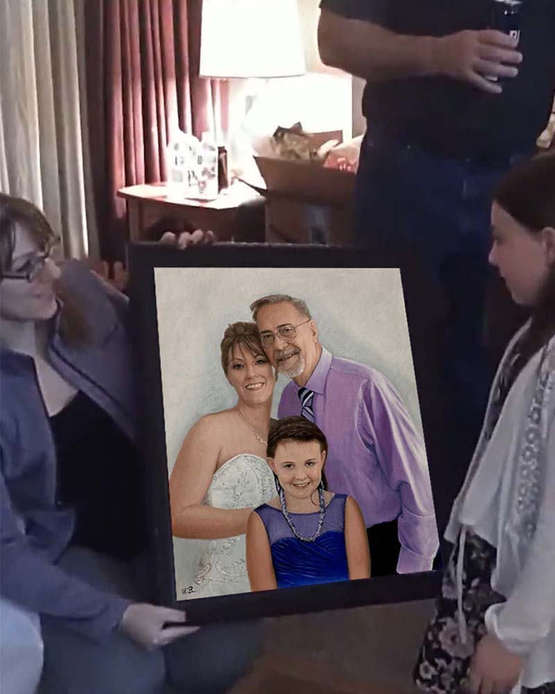 Framed portrait of a bride, groom, and two girls.