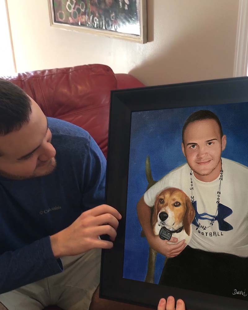 Framed portrait of a young man holding a beagle, a person looks at the painting.