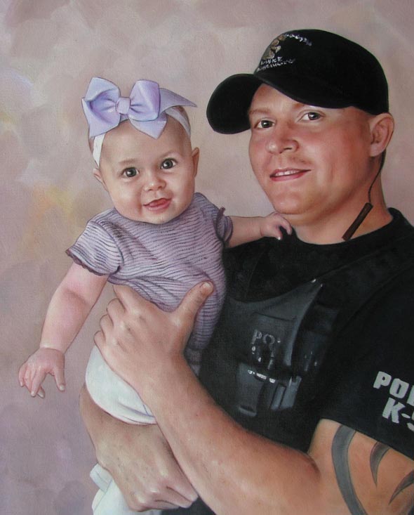 Portrait of a police officer holding a baby.