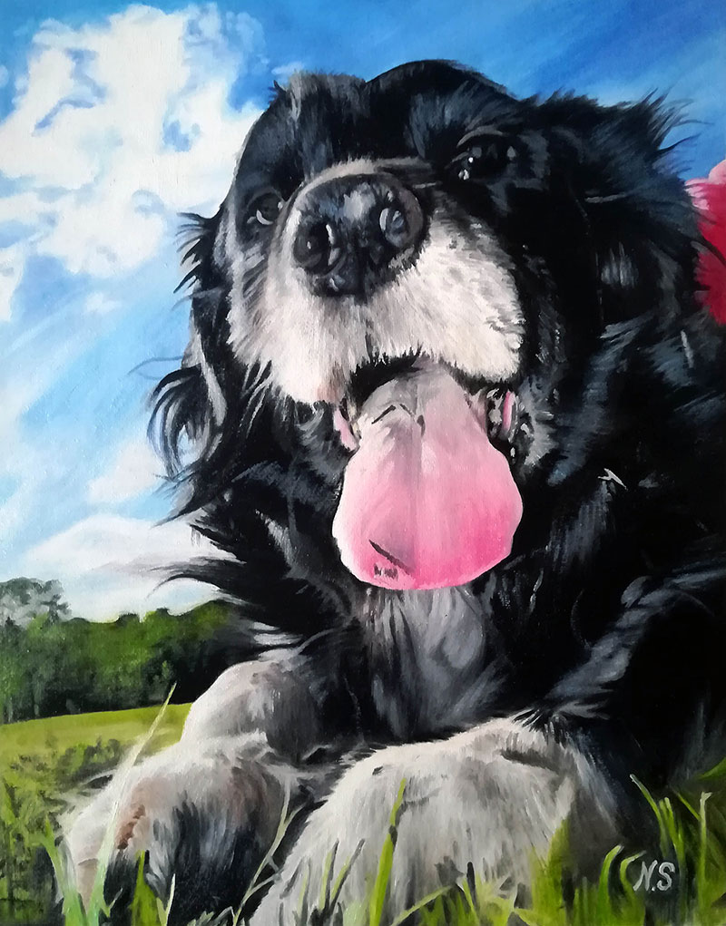 Painting of a happy black dog panting with its tongue out, lying in the grass under a blue sky.