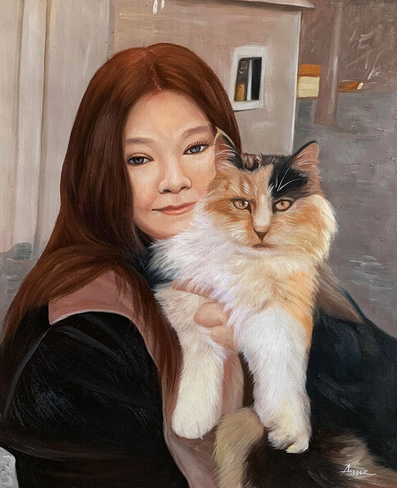 Painting of a woman holding a calico cat