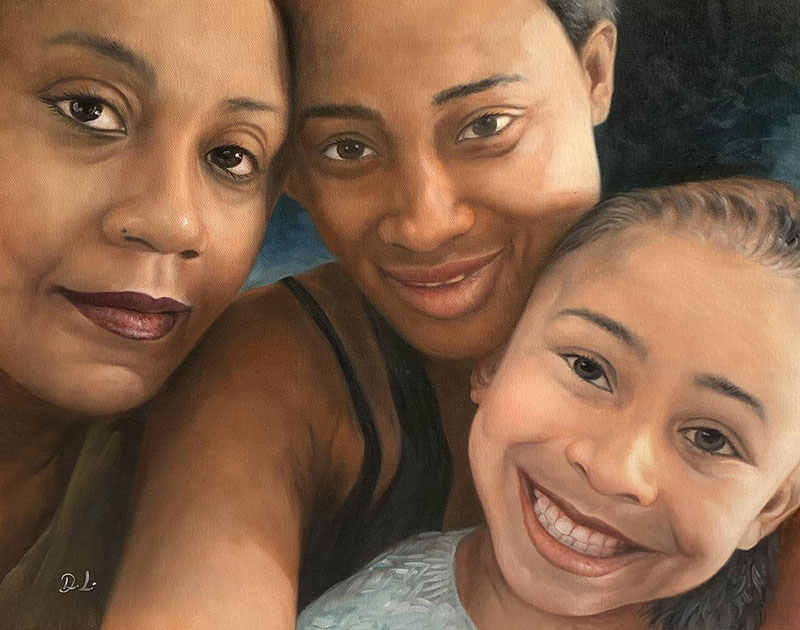 Portrait of two women and a child embracing.