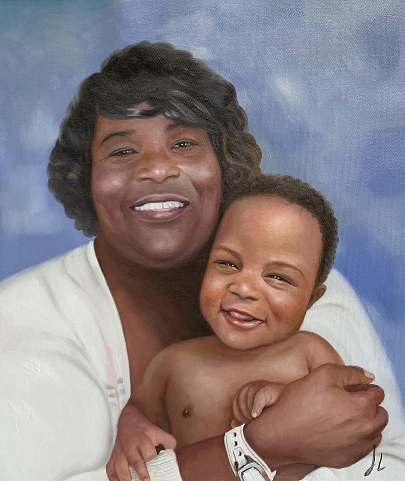 Portrait of a smiling woman embracing a baby.