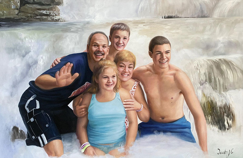 Family portrait in front of a waterfall.