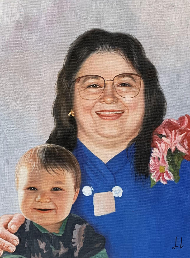 Oil painting portrait of a smiling woman wearing glasses and a blue shirt, holding a toddler.