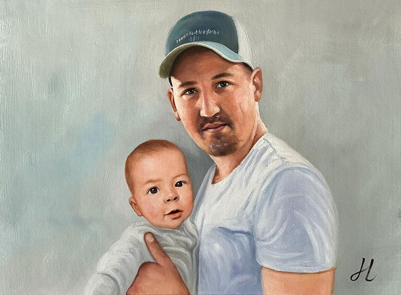 Custom handmade oil painting of a father holding a baby