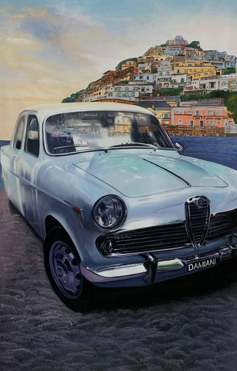 Painting of a light blue vintage car parked by the sea with a hillside town in the background.