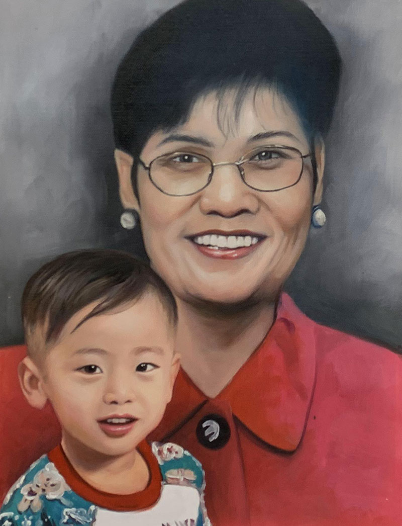 Oil painting of a smiling woman in glasses and a toddler.