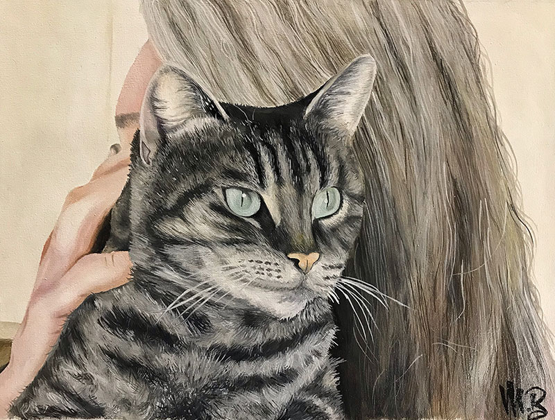 Painting of a tabby cat with green eyes being held by a person with long gray hair.