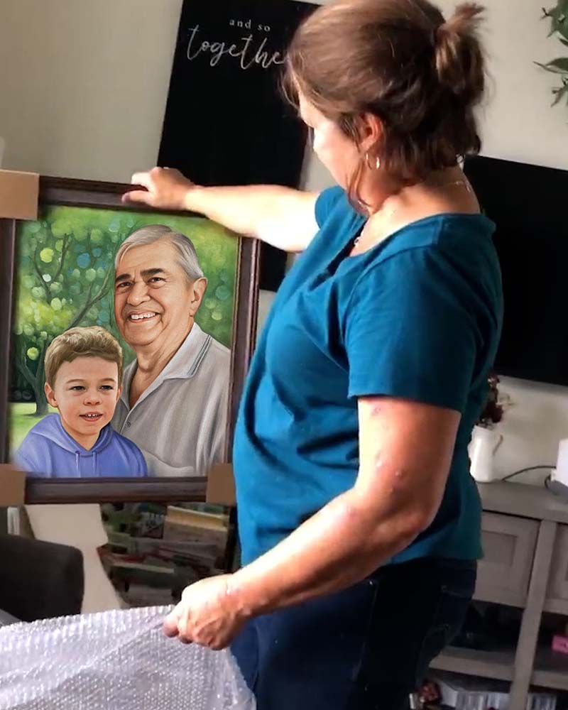 Woman unpackages framed portrait of older man and young boy.