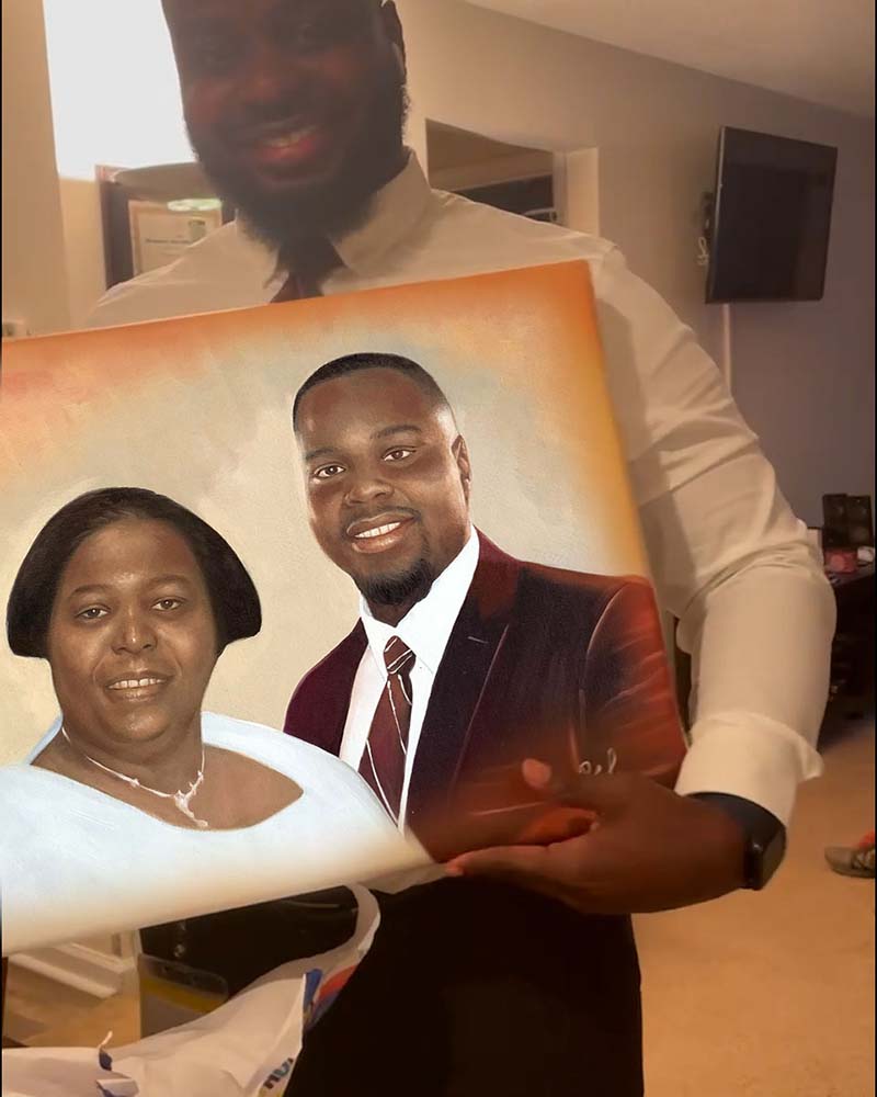 Man holding painted portrait of a couple.