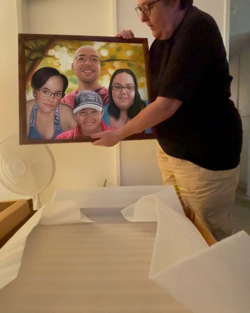 Person holding framed family portrait.