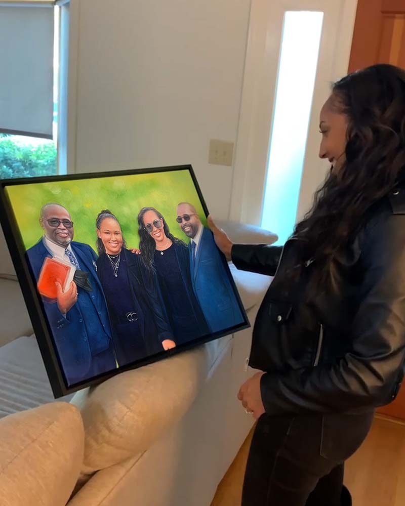 Woman holding framed family portrait