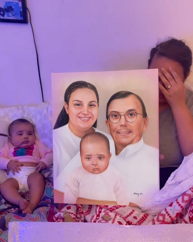 Family portrait painting revealed to emotional woman and baby.