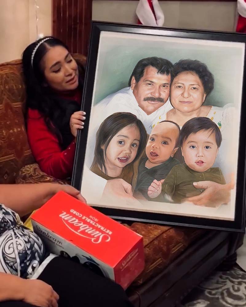 Woman presenting framed family portrait, Sunbeam retractable cord box in foreground.