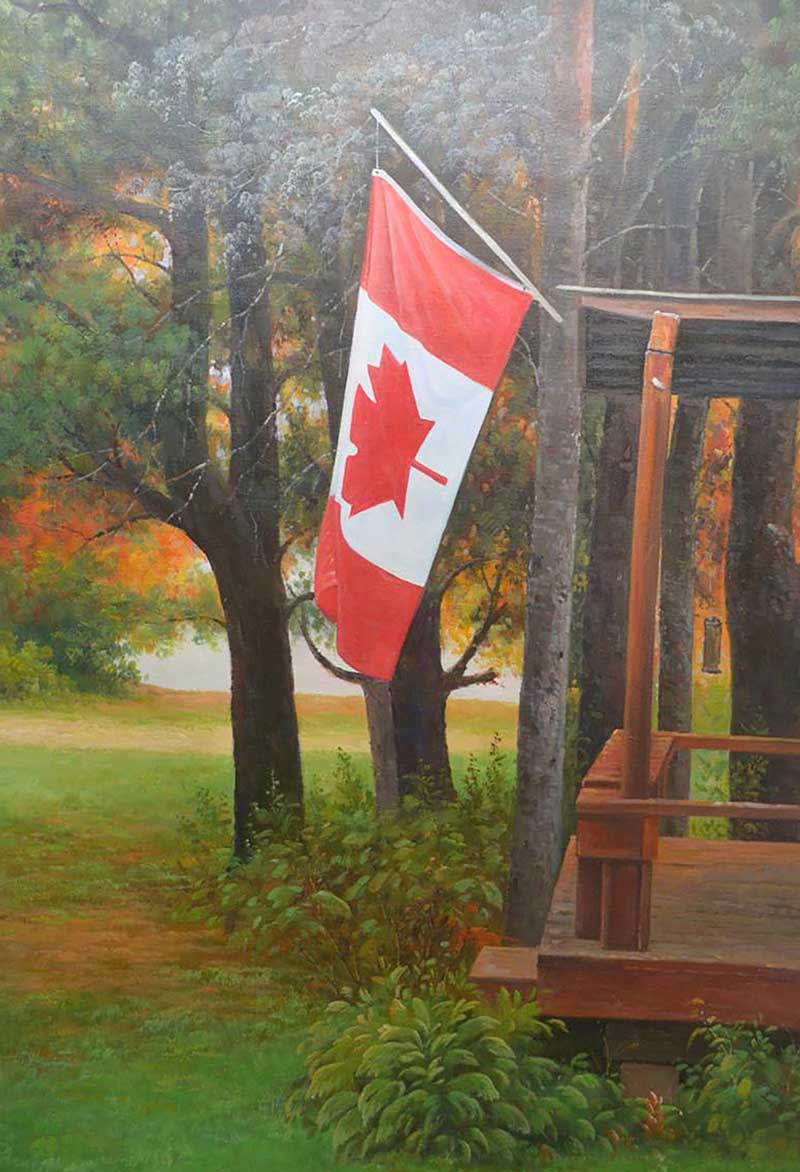 Canadian flag hanging from a porch, autumnal landscape in background.
