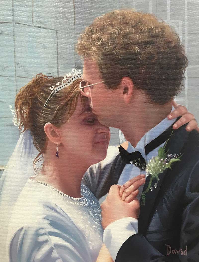 a custom wedding photo of a groom kissing bride on head