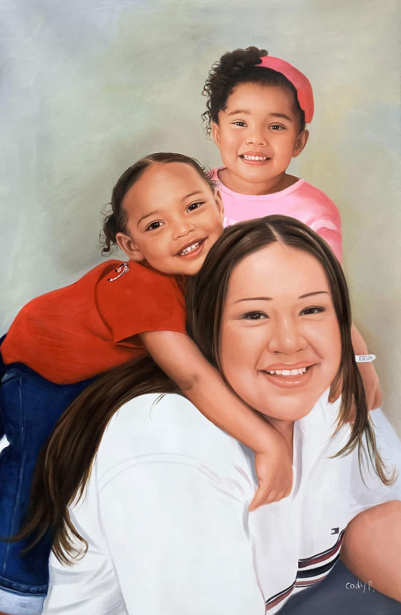 Portrait of a mother with her two young daughters hugging her from behind.