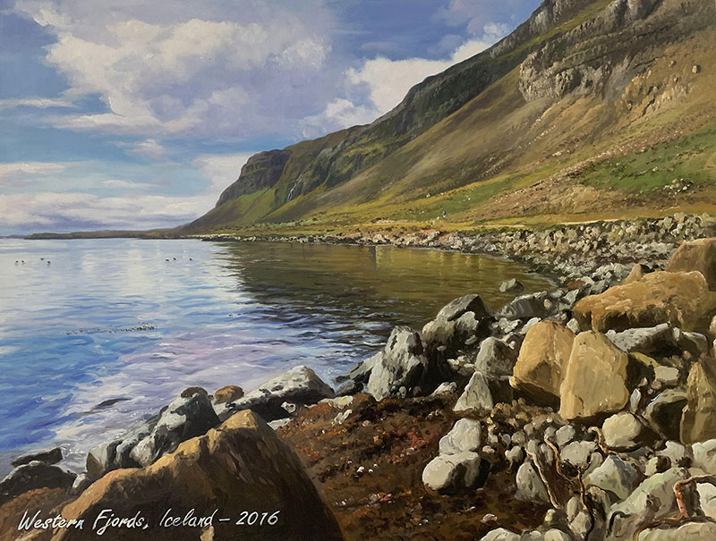 Painting of a rocky shoreline and calm water reflecting a steep, green hillside under a partly cloudy sky.