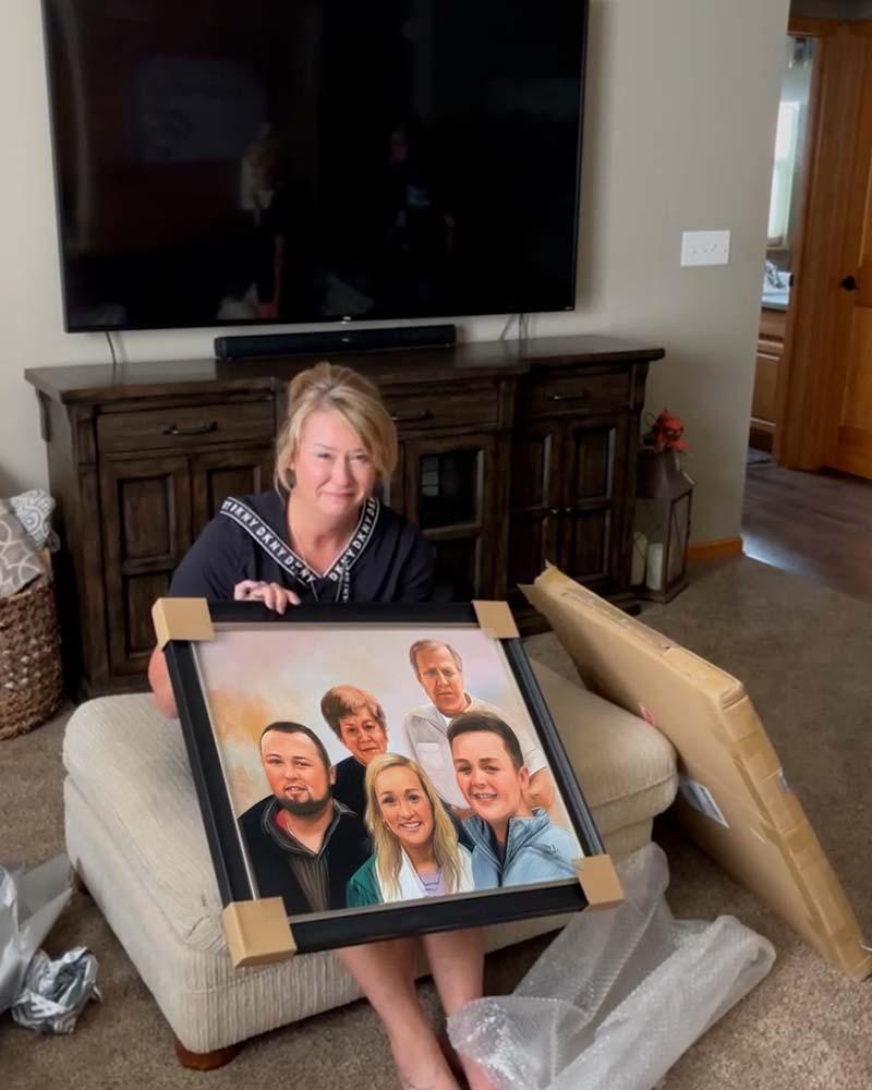 Woman holding framed family portrait painting.