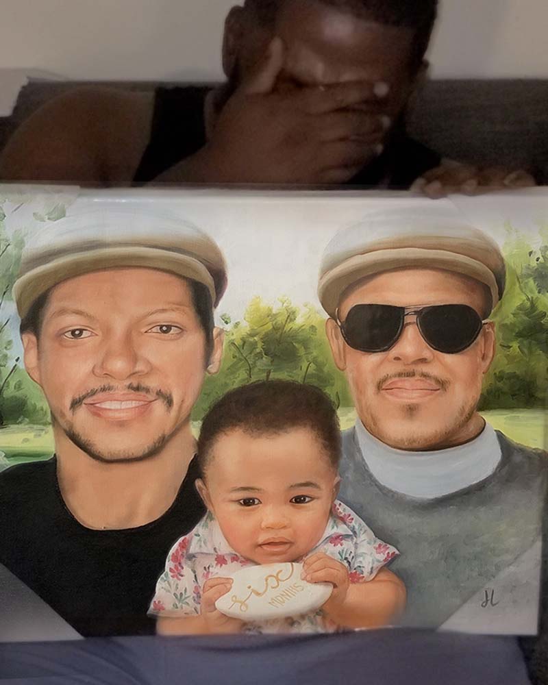 Portrait painting of two men and a baby, the baby holds a stone inscribed six months.