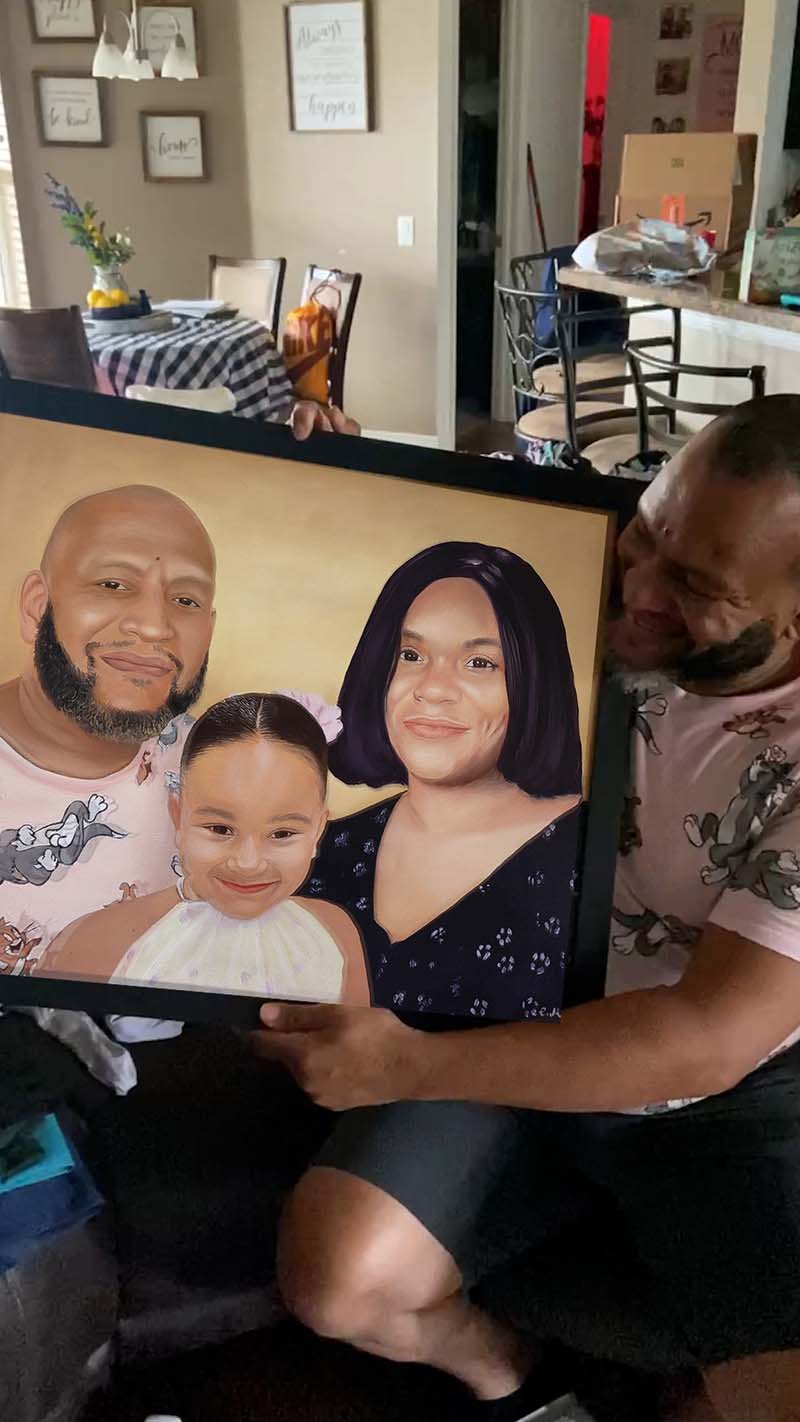 Framed portrait of a family: a man, woman, and young girl.