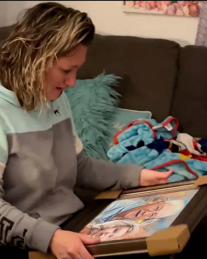 Woman opening framed portrait of two people, one appearing to be a baby.