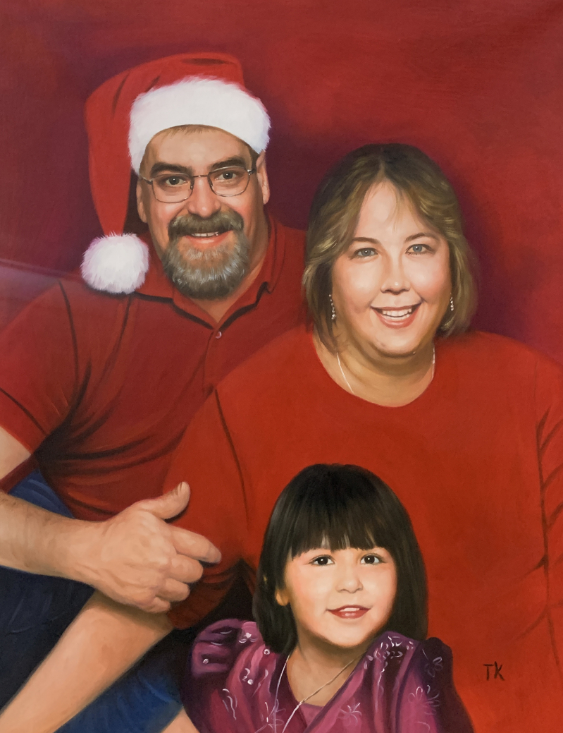 Family Christmas portrait: father wearing Santa hat, mother, and young daughter.