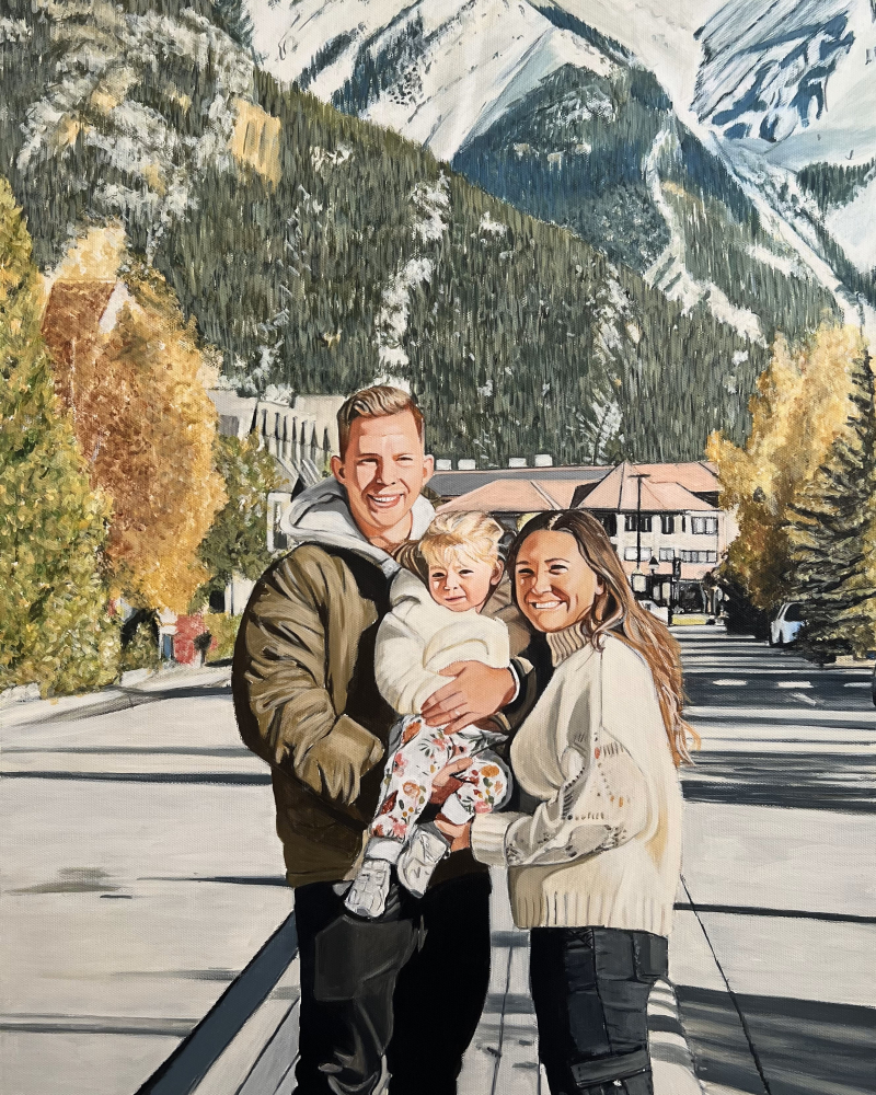 Family portrait in front of snowy mountains.