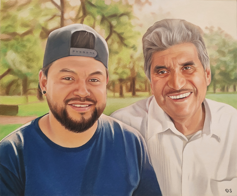 Portrait of a young man and older man smiling together outdoors.