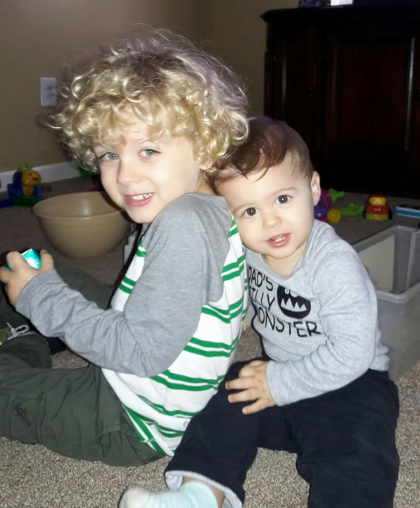 an oil painting of two kids together blonde redhead