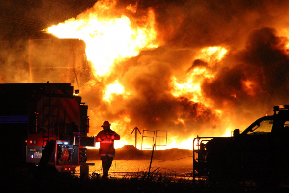 an oil panting of a fireman fighting the fire