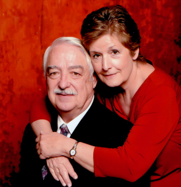 an oil painting of two loving elderly couple