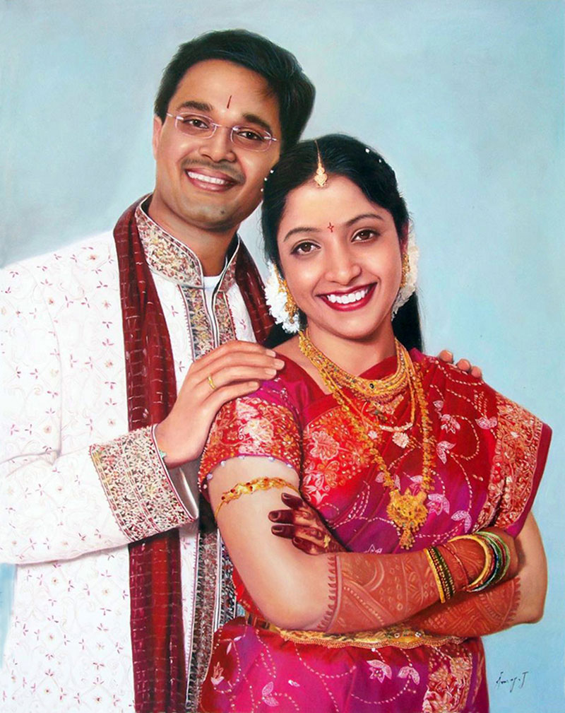 Portrait of a smiling couple in traditional Indian wedding attire.