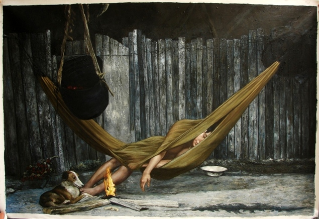 Person sleeping in a hammock near a small fire and dog, next to a wooden fence.