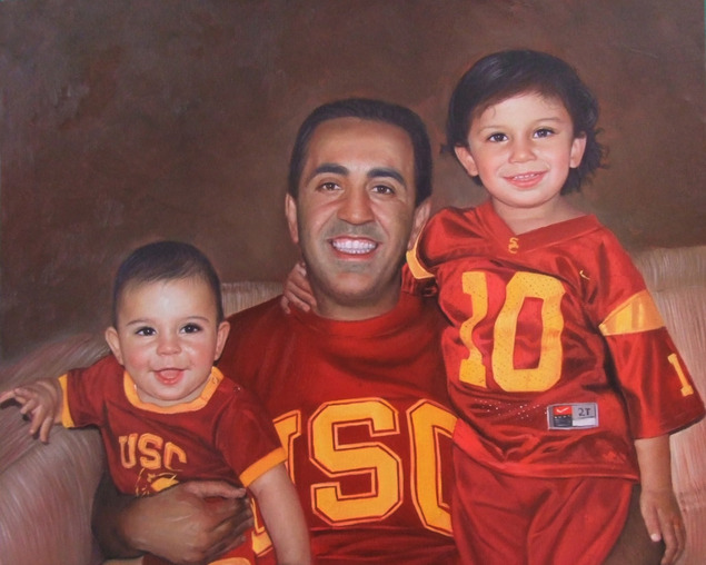 Oil painting of a father and his two young sons wearing USC jerseys.